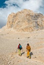 two girls on a walk in the mountains. girls with backpacks walk along a mountain path against the sky Royalty Free Stock Photo