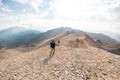 two girls on a walk in the mountains. girls with backpacks walk along a mountain path against the sky Royalty Free Stock Photo