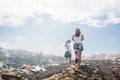 Two girls walking around garbage mountain Royalty Free Stock Photo