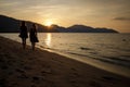 Two Girls Walking On Beach at Dusk