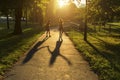 Two girls walking down the alley holding hands, during amazing sunset. Royalty Free Stock Photo