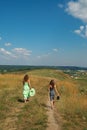 Two girls walking down the hill