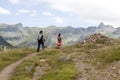 Two girls walking in the high of a mountain