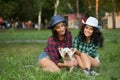 Two girls walking with his dog. cowboy hat and Royalty Free Stock Photo