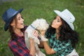 Two girls walking with his dog. cowboy hat and Royalty Free Stock Photo