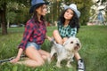 Two girls walking with his dog. cowboy hat and Royalty Free Stock Photo