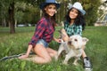 Two girls walking with his dog. cowboy hat and plaid shirt Royalty Free Stock Photo