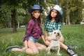 Two girls walking with his dog. cowboy hat and plaid shirt Royalty Free Stock Photo