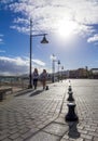 Two girls walking past the harbor harbour