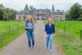 Two girls walking on road away from castle Royalty Free Stock Photo