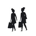 Two girls walking with shopping bags silhouette