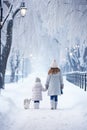 Two girls walking in the snow with a dog, AI Royalty Free Stock Photo