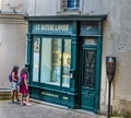 Two girls watching historic Le Bateau Lavoir store window