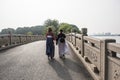 Two girls wearing ancient costumes walk in Harmony Lake Park