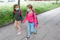 Two girls wearing protective face mask and going back to school during coronavirus pandemic. Royalty Free Stock Photo