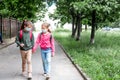 Two girls wearing protective face mask and going back to school during coronavirus pandemic. Royalty Free Stock Photo