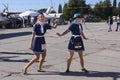 Two girls wearing stewardess uniform standing on a street in the VR glasses