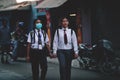 Two Girls Wearing Uniform Passing Thamel Street Go to School