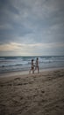 Two girls were walking along the kuta beach denpasar bali