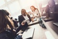 Two girls who work as operators in the call center talk to a black guy. Royalty Free Stock Photo