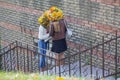 Two girls in wreaths of yellow leaves in the city park Royalty Free Stock Photo