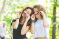 Two girs making moustache with their hair. Royalty Free Stock Photo