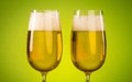 Two Glass of Beer on light green background. Craft Beer festival. Beer with foam in a pub. Royalty Free Stock Photo