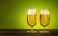 Two Glass of Beer on natural wooden table on green background. Craft Beer festival Royalty Free Stock Photo