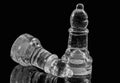 Two glass chess pieces on a black background Royalty Free Stock Photo
