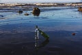Two glass bottles on the beach symbolizing recycling and ocean caring
