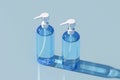 Two glass bottles filled with transparent liquid on a white background Royalty Free Stock Photo