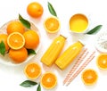 Two glass bottles of fresh orange juice, straws and oranges isolated on white background top view. Royalty Free Stock Photo