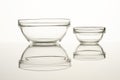 Two glass bowls on reflective surface. Royalty Free Stock Photo