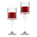 Two glass candlesticks with red candles isolated on white