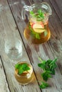 Two glass and carafe of green tea with mint and apples Royalty Free Stock Photo