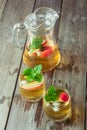 Two glass and carafe of green tea with mint and apples Royalty Free Stock Photo