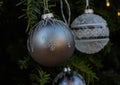 two glass christmas tree balls with snowflake design hanging outside in tree Royalty Free Stock Photo