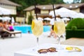 Two Glass of classic cocktail and sunglasses, at blue swimming pool. Vacation, summer, holiday, luxury resort concept. Royalty Free Stock Photo