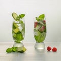 Two glass of cocktail, classic Mojito and Mojito with raspberries