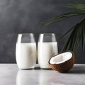 Two glass of coconut milk and coconuts