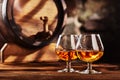 Two glass of Cognac and old oak barrel defocussed Royalty Free Stock Photo