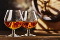 Two glass of Cognac and old oak barrel defocussed Royalty Free Stock Photo