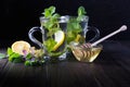 Two glass cups fresh mint tea with lemon and honey