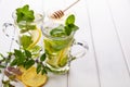 Two glass cups fresh mint tea with lemon and honey