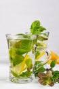 Two glass cups fresh mint tea with lemon and honey