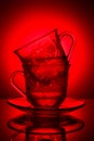 Two glass cups with a pattern, with fragrant tea on a red background Royalty Free Stock Photo