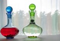 Two glass decanters with fruit and berry drinks