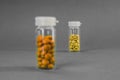 Two glass flasks with yellow and orange tablets. black and white photo