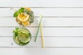 Two glass glasses with homemade lemonade from lime and lemon, cocktail tubes on a white wooden rustic background Royalty Free Stock Photo