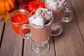 Two glass of hot creamy cocoa with froth with autumn leaves and pumpkins on the background Royalty Free Stock Photo